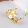A gold-toned mini pearl tiara crown used as a cake topper or hair accessory.