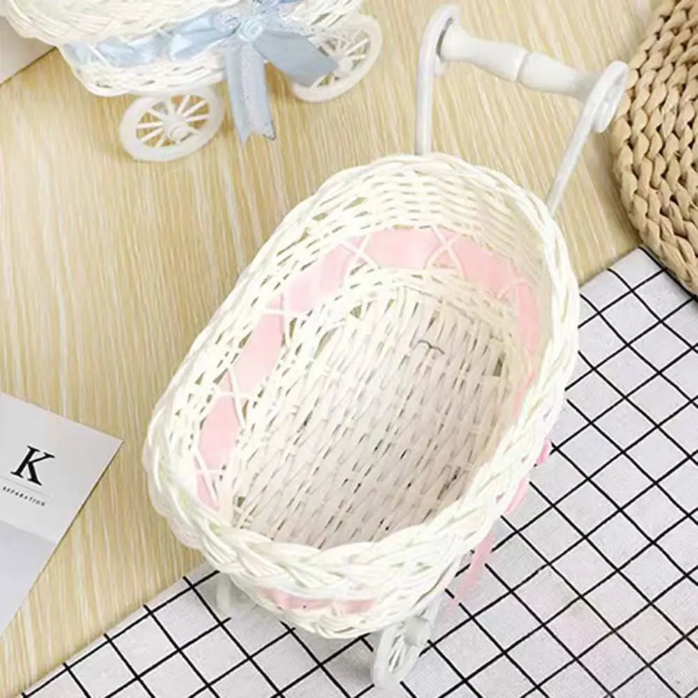 A white faux rattan woven storage basket with a pink interior and a handle is shown on a light wooden surface.