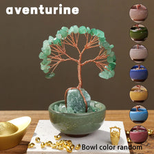 A natural crystal money tree with rose quartz base featuring green crystal leaves in a bowl.