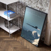 A framed canvas wall art poster depicting a Lockheed SR-71 Blackbird jet flying above clouds.