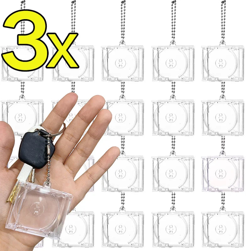 Three mini transparent CD keychains hanging from a chain, shown next to a hand.