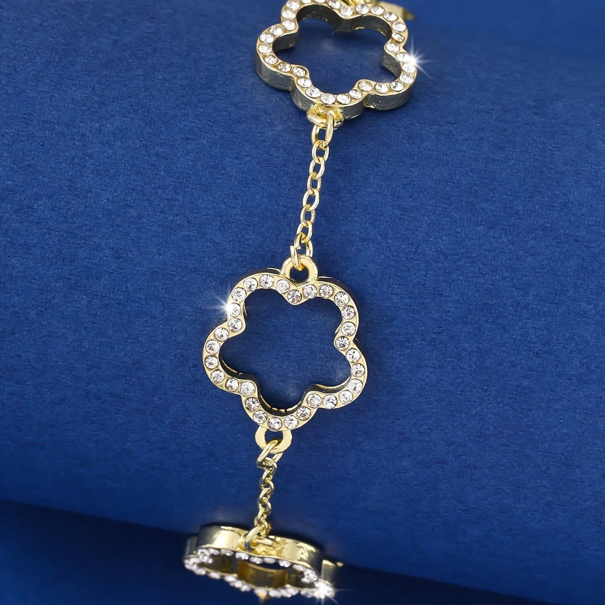 Gold-plated cubic zirconia flower bracelet with a chain and a decorative charm