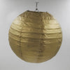 A large, round, golden paper lantern suspended by a wire hanger.