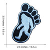 A black embroidered iron-on patch shaped like a large human footprint.