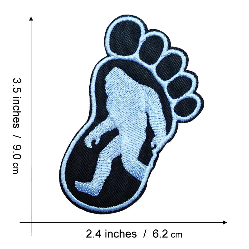 A black embroidered iron-on patch shaped like a large human footprint.