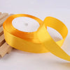 Roll of gold yellow satin ribbon used for crafts and gift wrapping