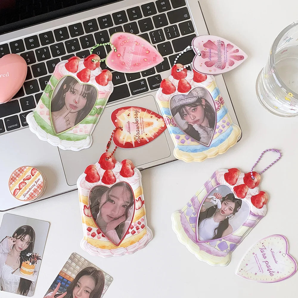 A collection of pink and green strawberry-themed bag keychains, card holders, and decorative items arranged on a white surfac