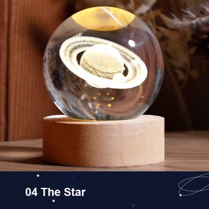 A glass crystal ball containing a glowing galaxy design rests on a light wooden base.