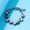 A silver charm bracelet featuring miniature figures of Itadori, Fushiguro, and Gojo from Jujutsu Kaisen.