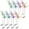 A collection of realistic dragonfly hat clips in various colors hanging from strings.