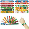 A hand holds a collection of colorful Christmas cartoon slap bracelets for kids.