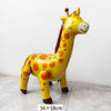 A yellow inflatable giraffe decoration for birthday parties with orange spots.