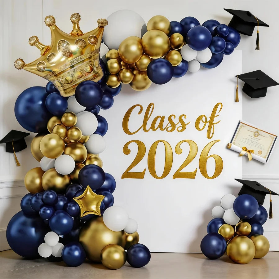 A balloon arch display featuring navy blue, white, and gold balloons arranged in a crown shape for a graduation theme.