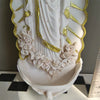White resin Virgin Mary holy water wall decor featuring gold accents and a floral wreath