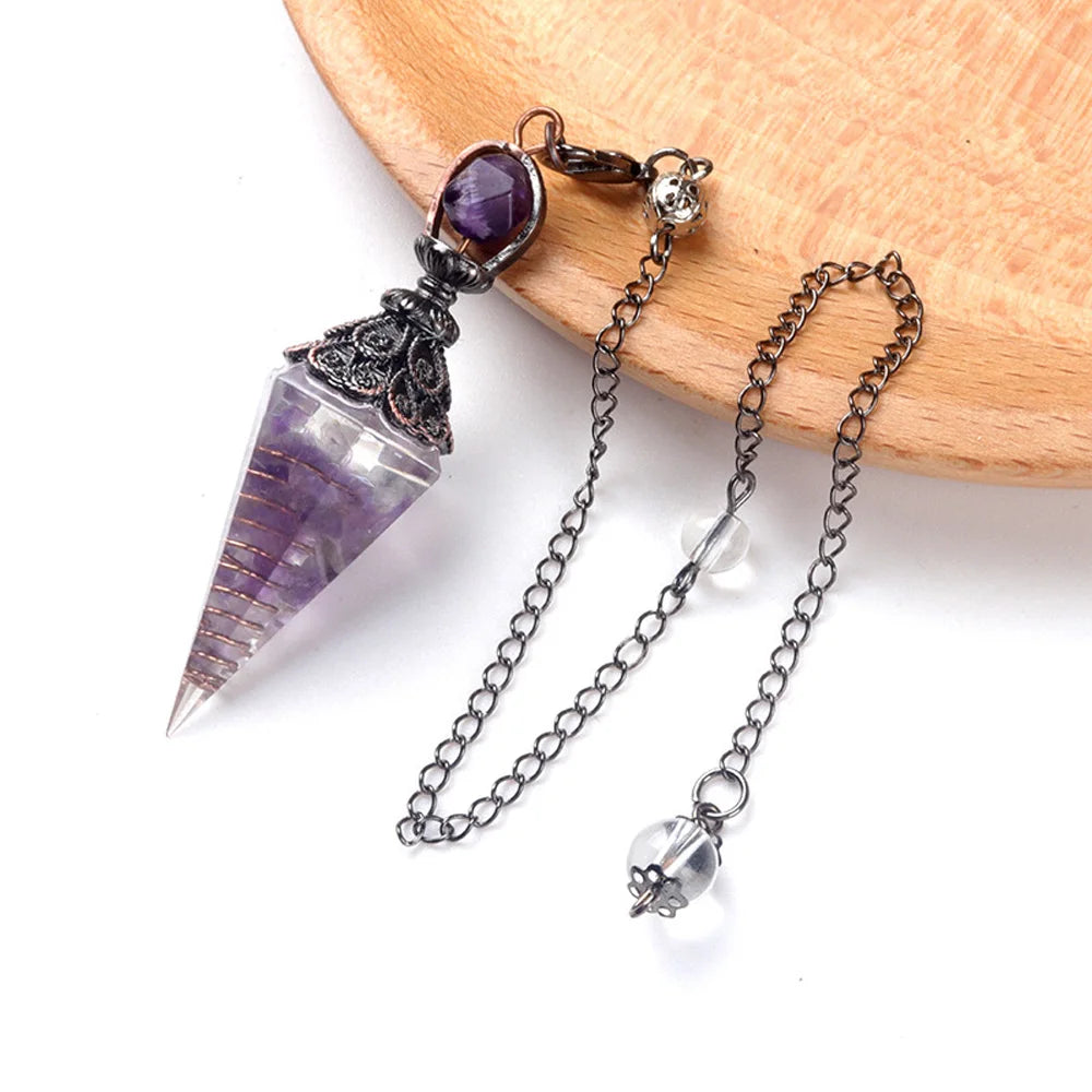 A natural crystal pendulum necklace set featuring a purple amethyst point suspended on a silver chain.