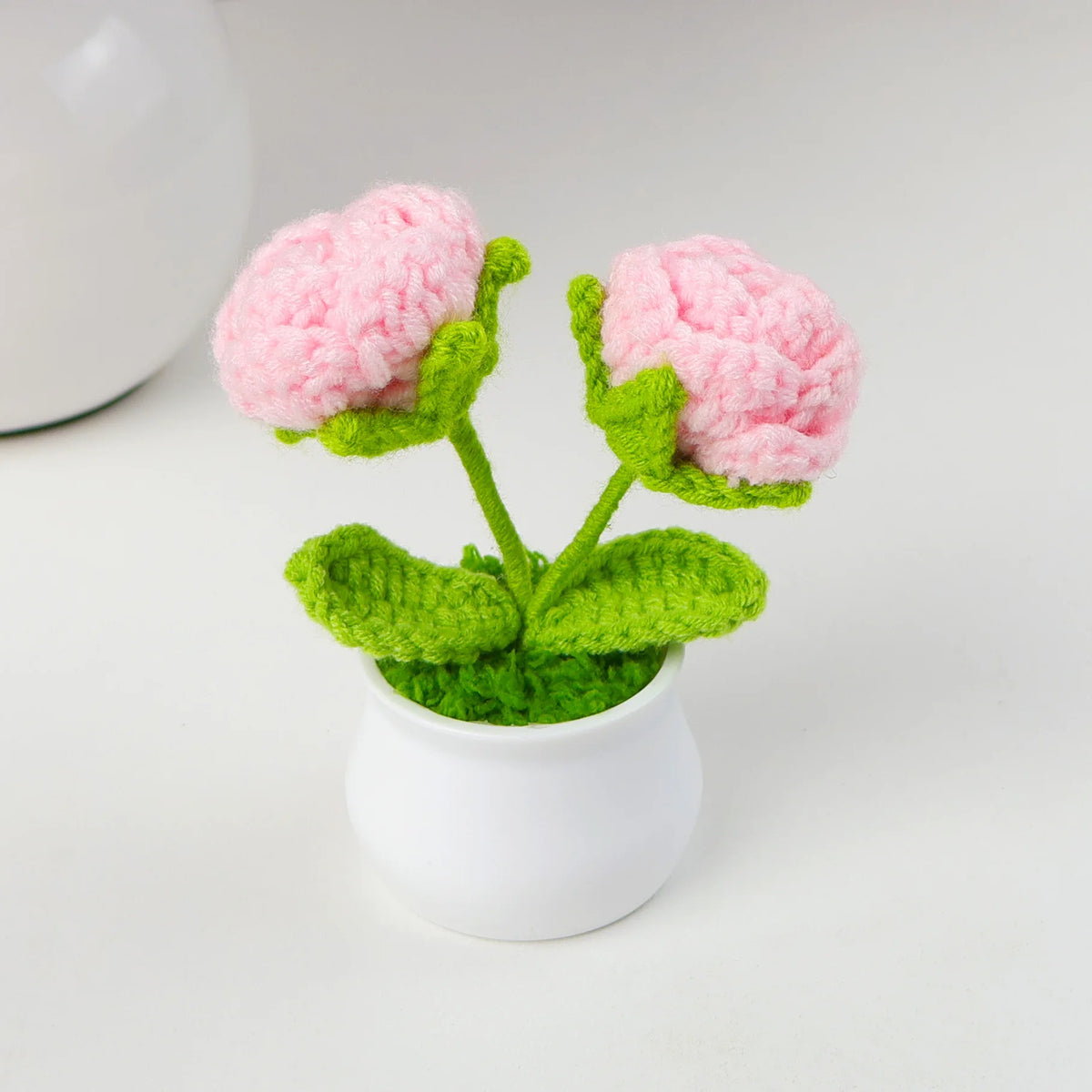 Hand woven crochet pink and green flowers in a white pot