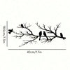 Black silhouette of three birds perched on a bare tree branch, used as wall art.