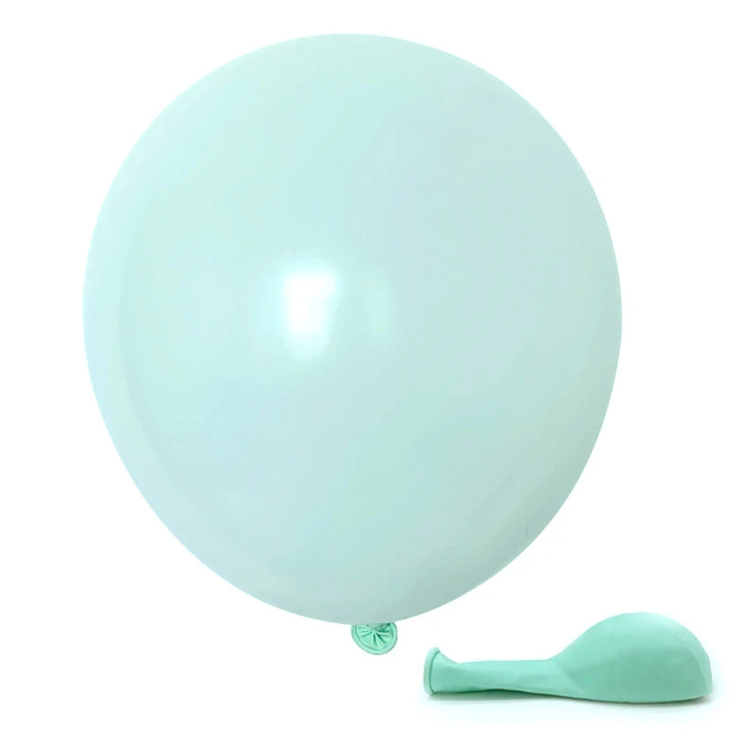A large, round, pale mint green balloon is shown next to a small, light green silicone tool.