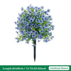 A bouquet of blue artificial petunias with green leaves arranged on a black stake.