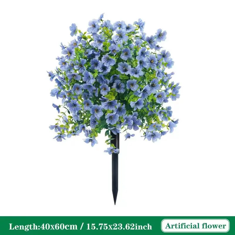 A bouquet of blue artificial petunias with green leaves arranged on a black stake.
