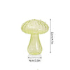 Vase décoratif en verre vert clair en forme de champignon, avec un large chapeau et une base étroite.