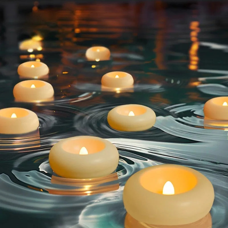 A close-up of glowing yellow LED floating sensor tealight candles reflecting on dark water.