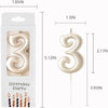 Gold number candles shaped like the number three for birthday party decor