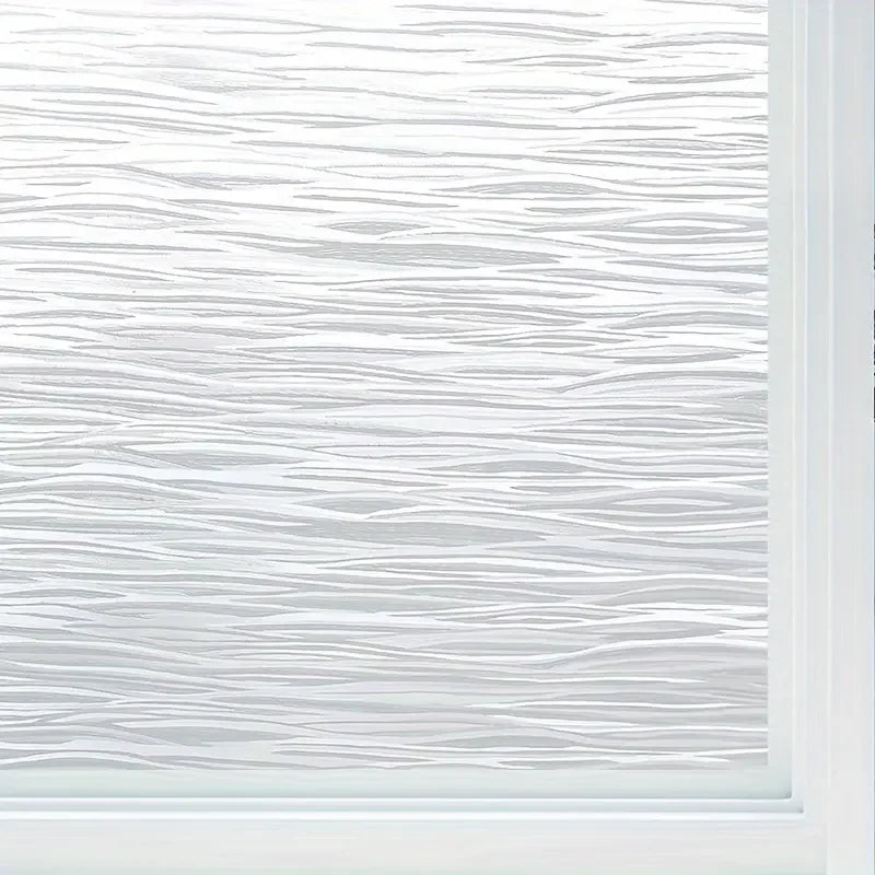 Close-up of frosted electrostatic window film with horizontal white lines for privacy