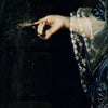 A hand in a blue dress reaches toward a dark surface, interacting with a textured or misty substance.