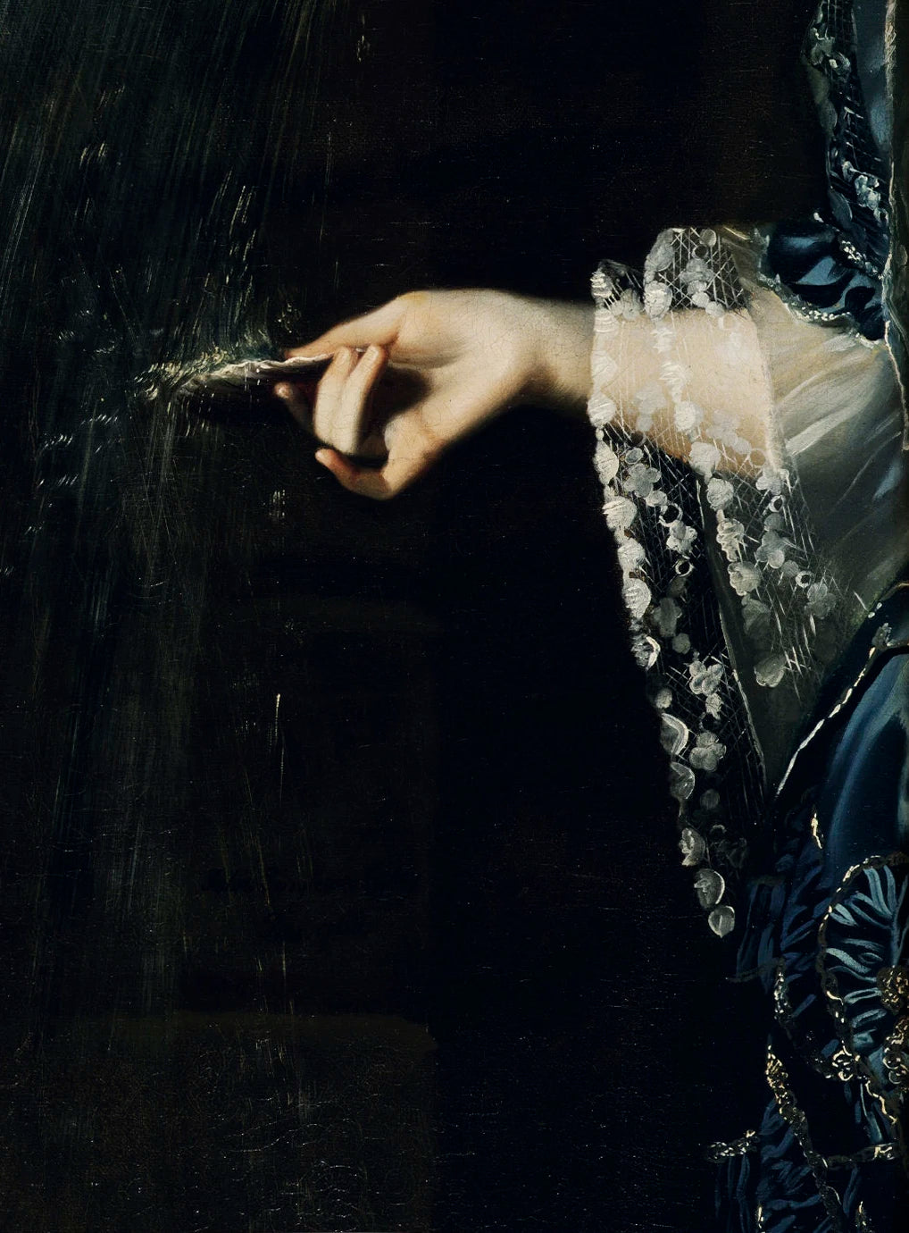 A hand in a blue dress reaches toward a dark surface, interacting with a textured or misty substance.