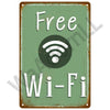 A weathered green metal plaque with the text Free Wi-Fi and a white Wi-Fi symbol.