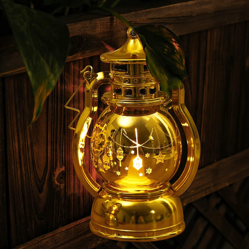 A golden LED lantern night light with a handle and decorative elements, emitting a warm glow.