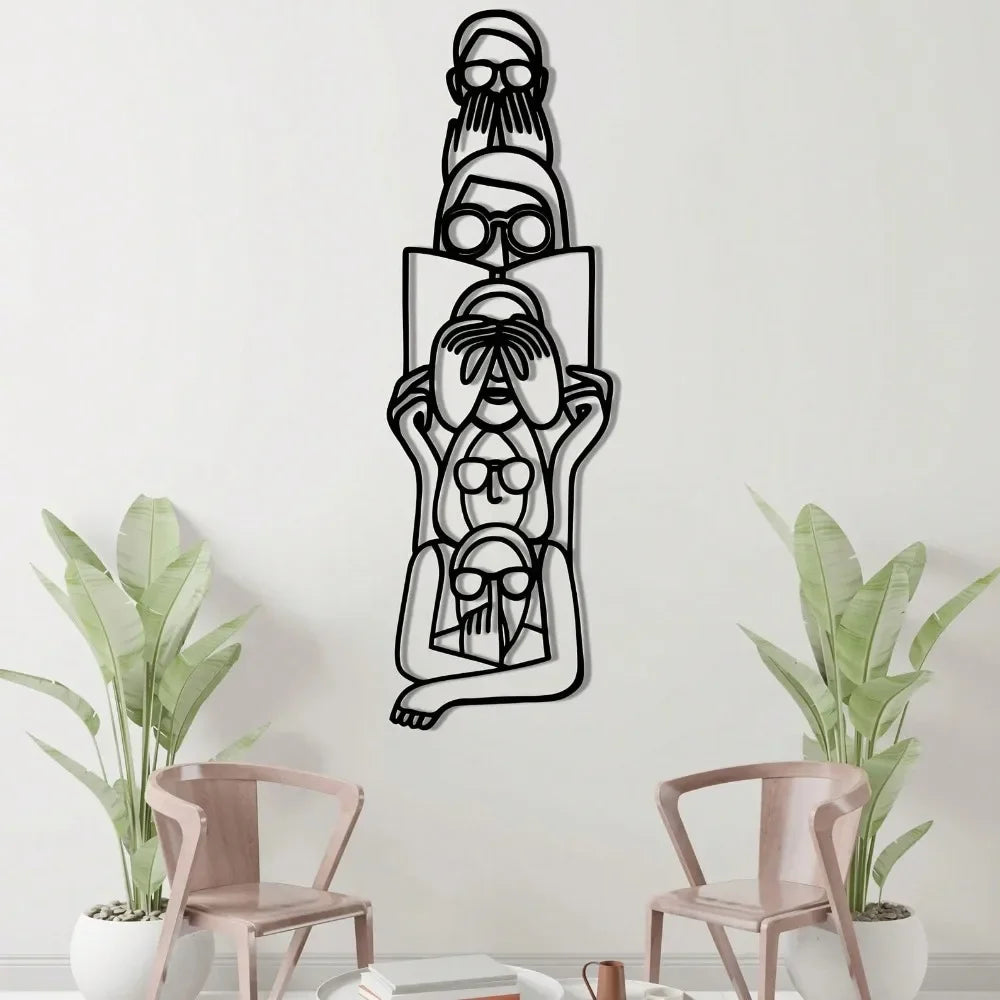Black metal silhouette wall art featuring a minimalist cat and woman design on a white wall.