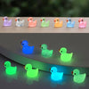 A set of colorful resin mini mushroom figurines displayed on a dark surface.