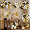 A display of black, gold, and white graduation balloons featuring cap and star designs.