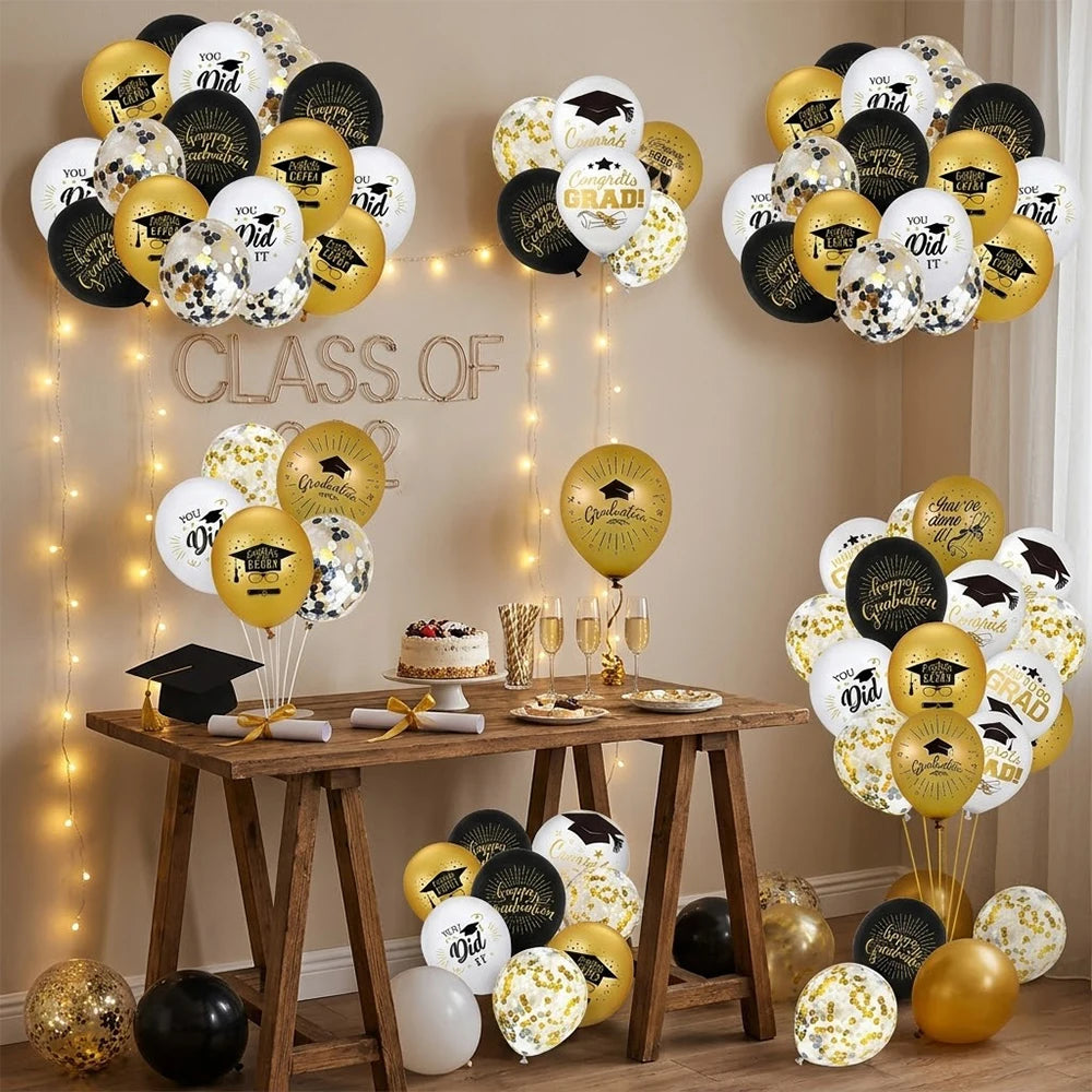 A display of black, gold, and white graduation balloons featuring cap and star designs.