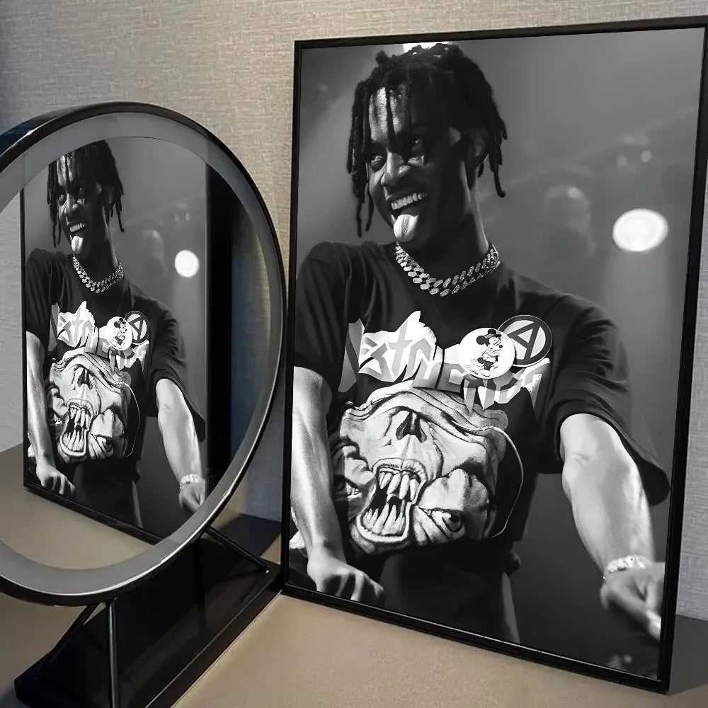 Black and white photo of Playboi Carti with dreadlocks smiling, displayed in a circular frame.