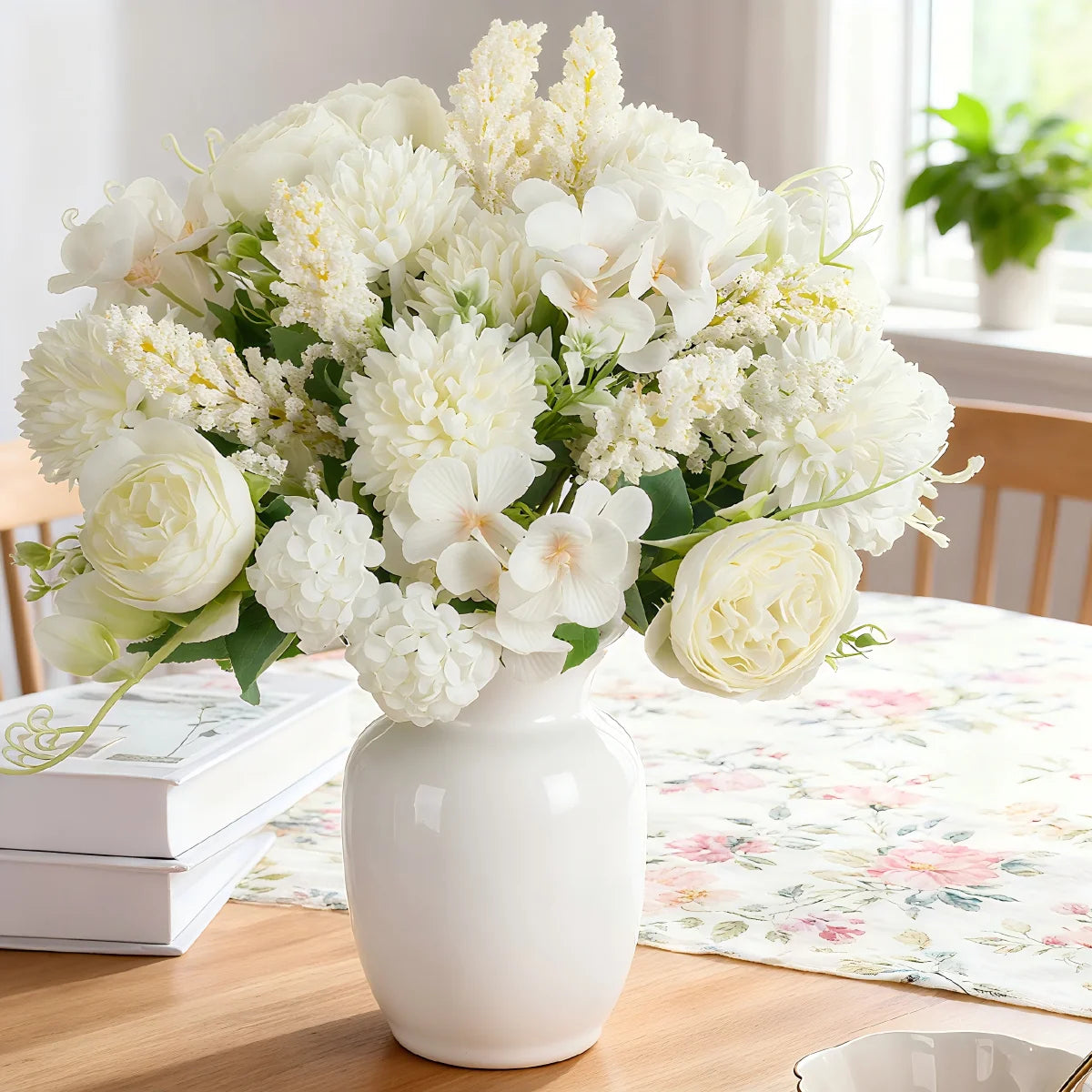A bouquet of white artificial silk peony flowers in a white vase on a wooden table.
