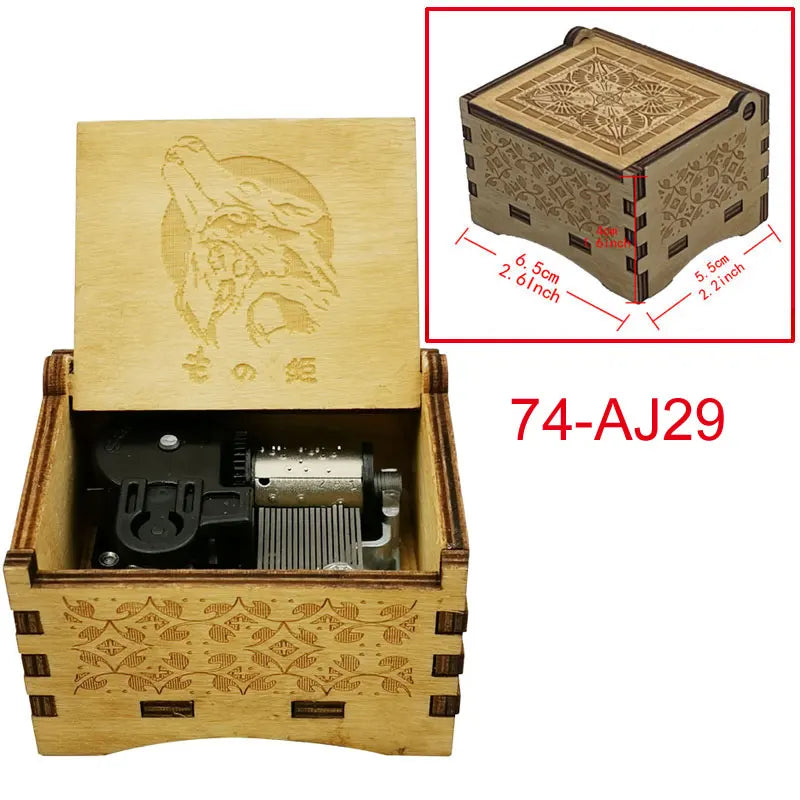 A wooden music box with an engraved bird design and a lid showing internal mechanisms.