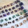Rolls of floral PET stickers featuring various dark and muted colored flowers for journaling and scrapbooking