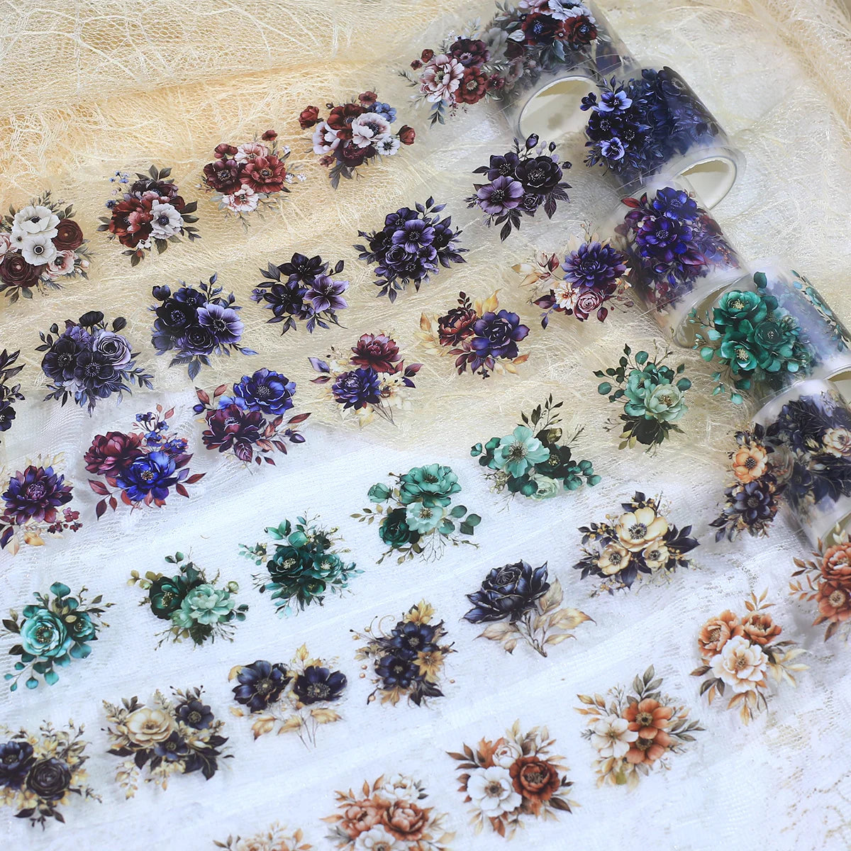 Rolls of floral PET stickers featuring various dark and muted colored flowers for journaling and scrapbooking