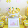 A display of yellow lemon-themed cake toppers, including fruit slices and lemon-shaped decorations.