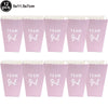 Twelve pink foil baby bottle balloons with the text Team Girl for baby shower decor