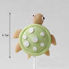 A set of five ocean animal cake toppers, including a crab and turtle, made of light green fondant or gum paste.