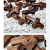 A collection of handcrafted wooden crosses with epoxy hearts, displayed on a light surface.