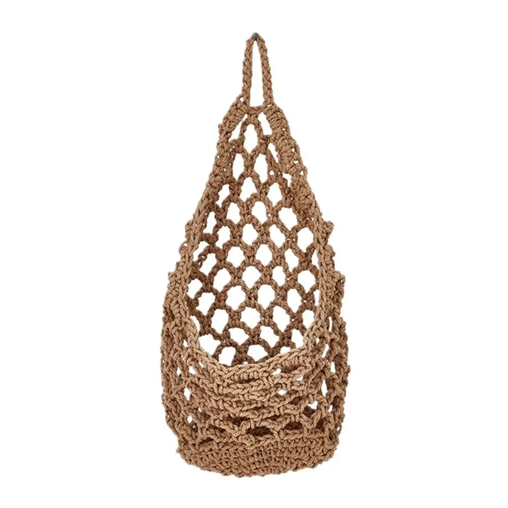 A handcrafted boho macrame hanging storage basket made of natural beige fiber.