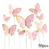 A collection of 50 paper butterfly cake toppers in shades of pink and gold.
