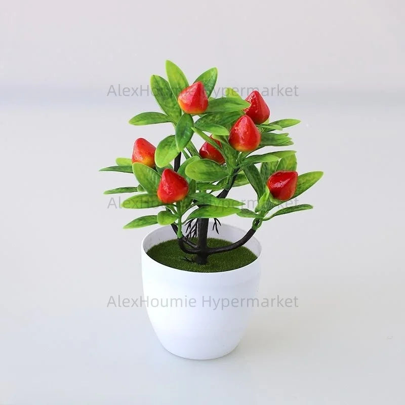 Artificial lemon tree bonsai with bright red fruit growing in a white pot