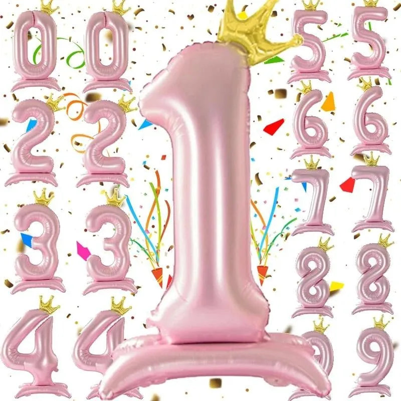 A collection of pink aluminum foil crown number balloons forming the number one.