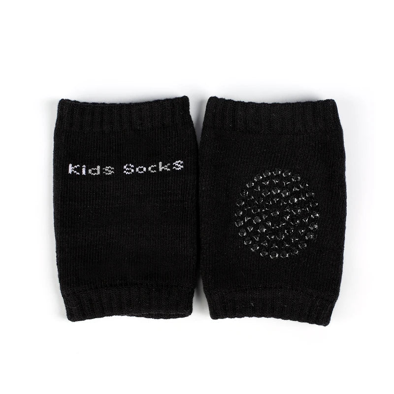 A pair of black knitted socks with the text Kids Socks on the cuff.